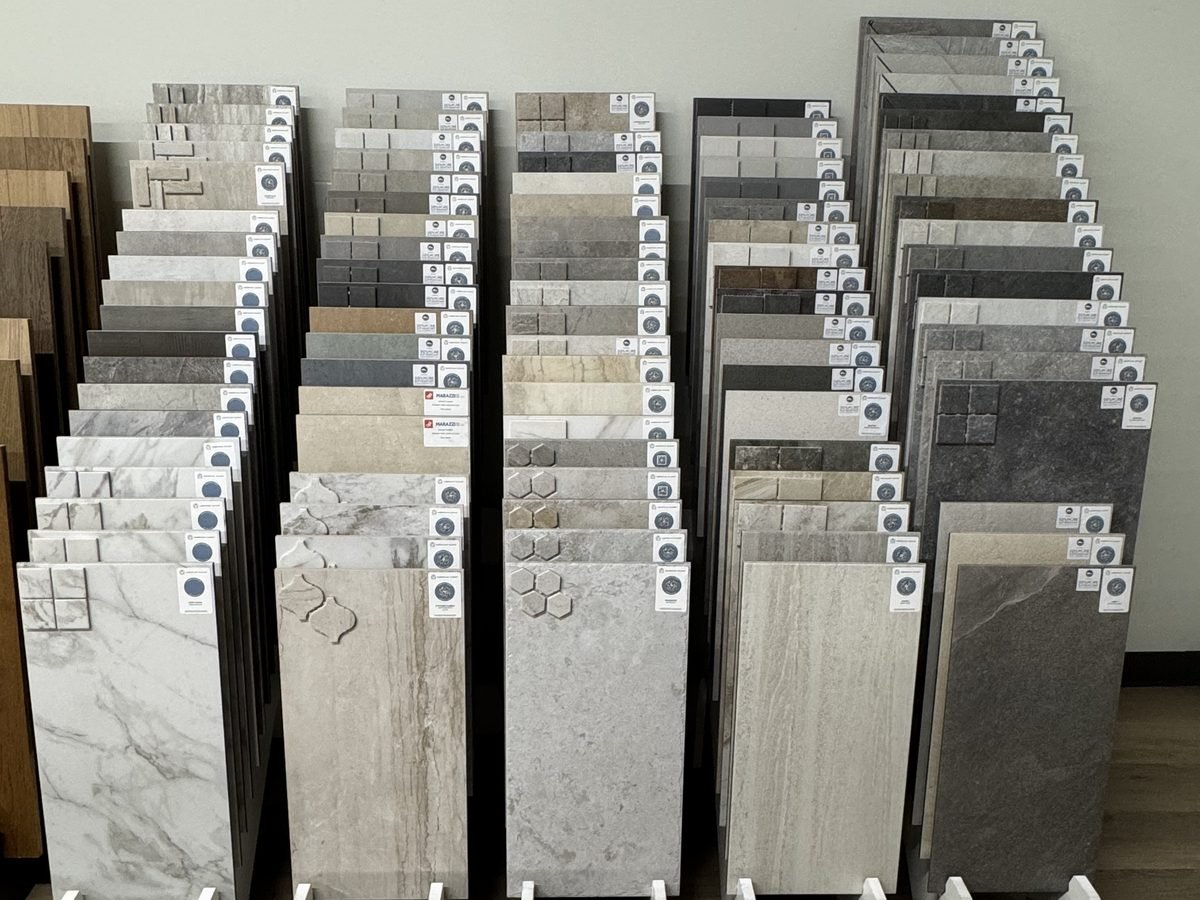 Wood-look porcelain tile planks shown on a showroom display rack