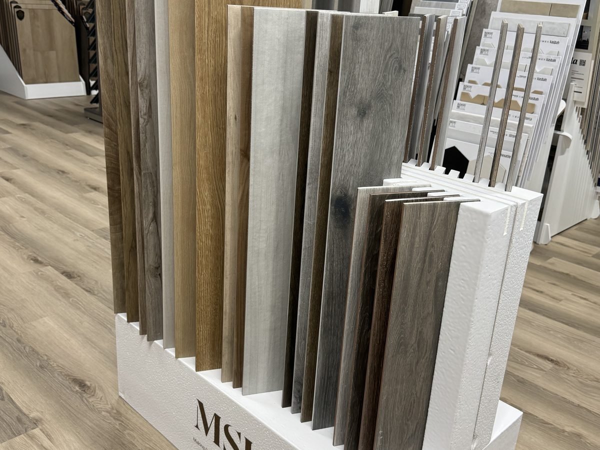 Marble-look tile samples arranged for comparison at the showroom